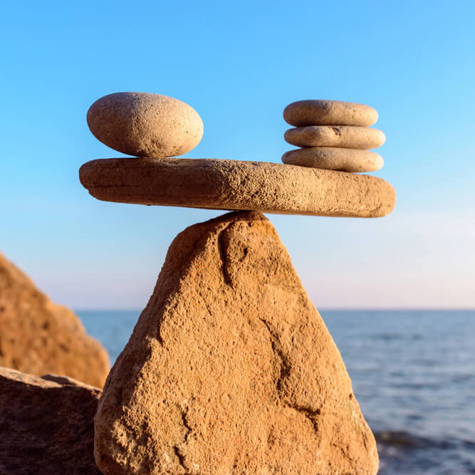 Balanced stones on a rocky surface.